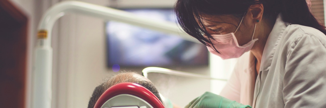 Why All Doctors Need to Know About Chronic Fatigue Syndrome Dentist examines the teeth of patient