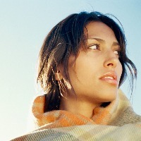 low angle view of a young woman wrapped in a blanket