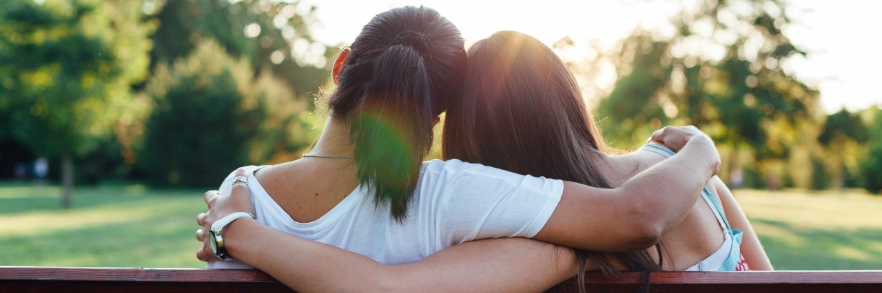 25 Ways to Be a Good Friend to Someone With Lyme Disease Closeup of two women embracing on a park bench