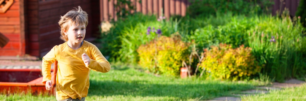 How I'm Learning to Let My Autistic Son Have Independence boy running in the garden