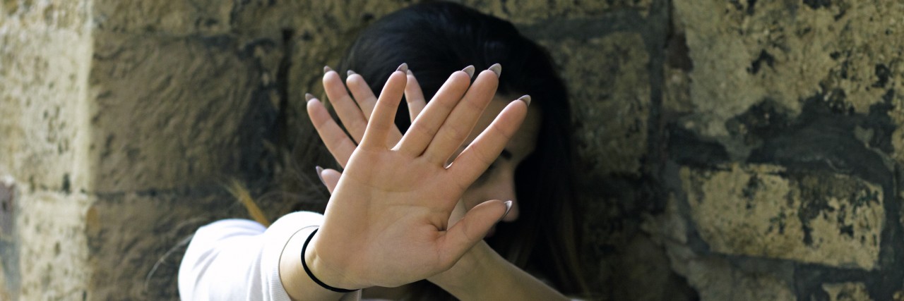 When Anxiety Convinces Me Everyone Is Judging My Appearance woman blocks her face with her hands