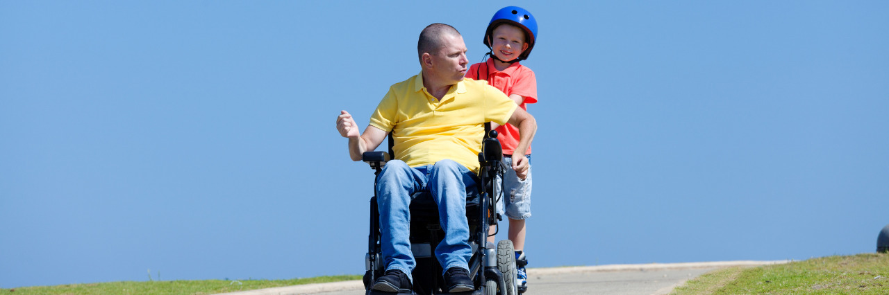 Educating Teachers About Parents With Disabilities Father in a wheelchair playing with his son.
