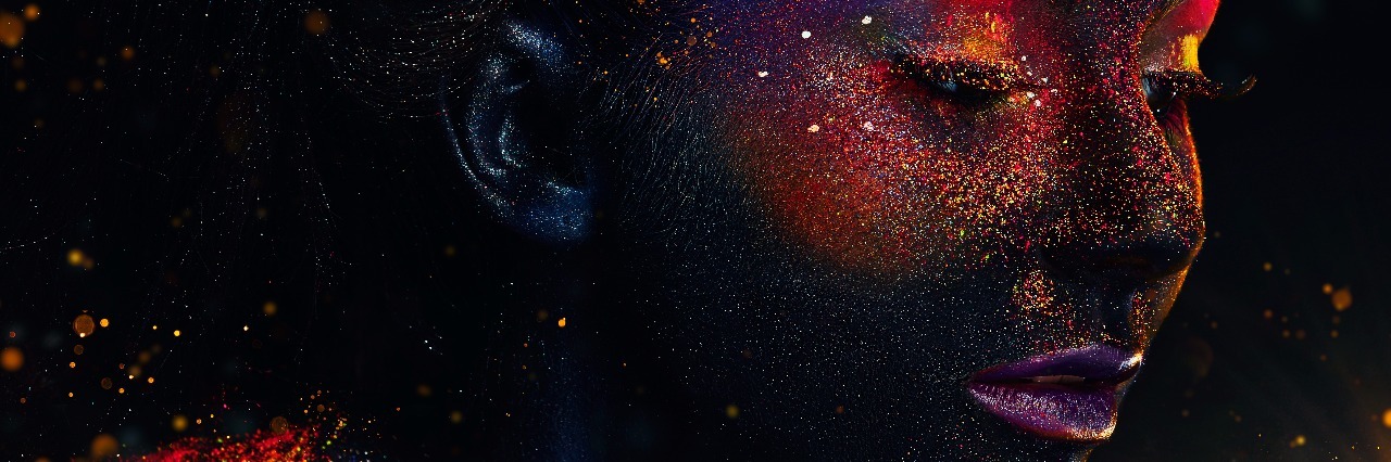 How Crohn's Disease Helped Me Redefine What Success Means to Me Glowing neon makeup with dramatic look in his eyes. Creative body art on the theme of space and stars. Amazing close-up portrait glow in the dark makeup.