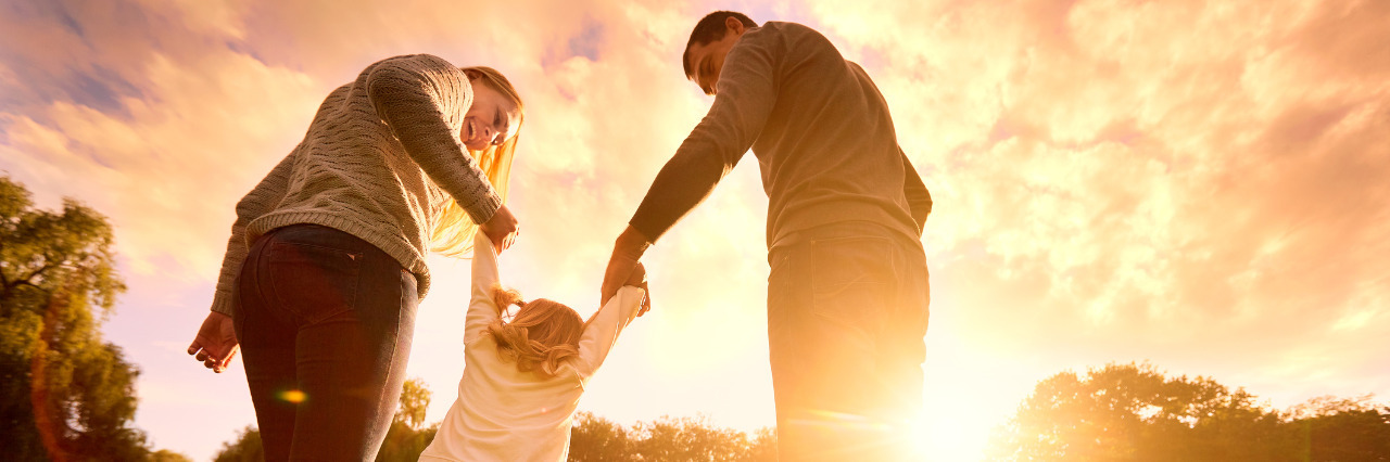 Realizing 'Milestones' Aren't Everything as Parent of a Child With HIE Happy family in the park at sunset.