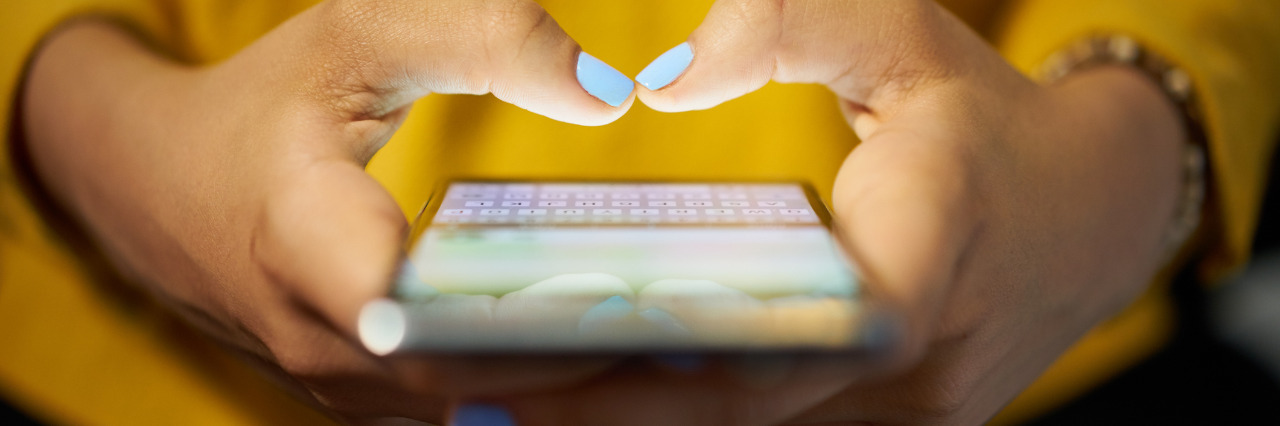 Being Honest About My Family's Medical Challenges on Social Media Woman using cell phone to send message on social network at night.