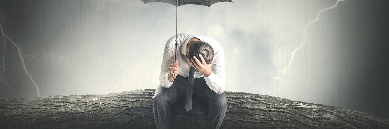 The Morning After a Mental Breakdown A man sitting on a branch in the rain, holding an umbrella