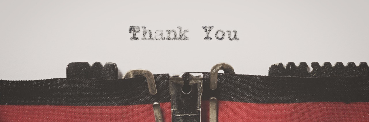 Word "thank you" written on a vintage typewriter