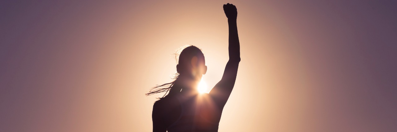 What It Means to 'Be Strong' With POTS silhouette of a woman pumping her fist in the air