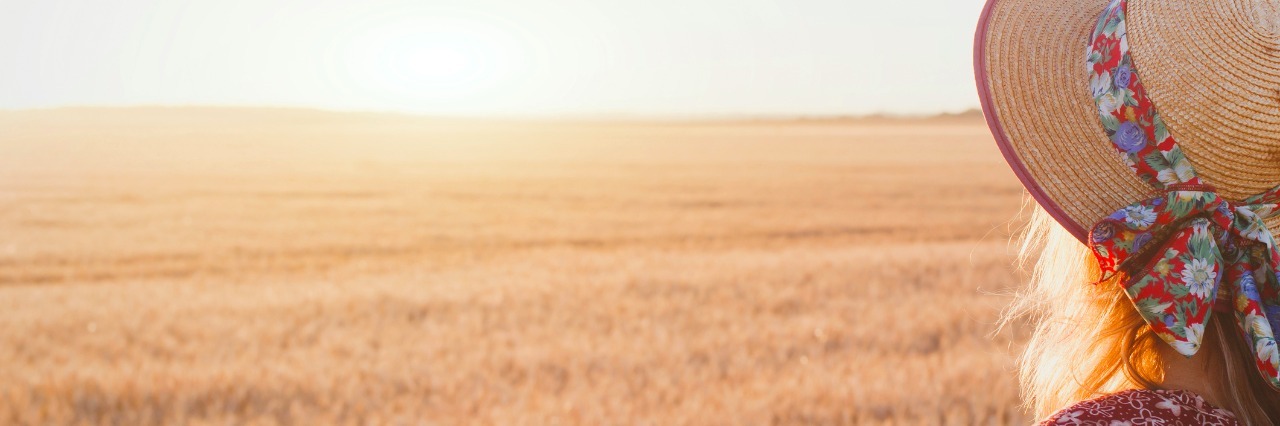 What It's Like Living With Hidradenitis Supperativa woman enjoying summer sunset