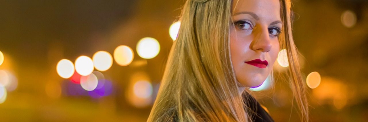 I Don't Believe Depression's Lies Anymore, but I Can't Ignore Them Young woman on the night city street.