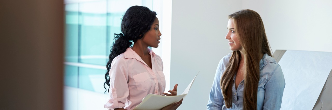 Importance of Patient Advocacy and Speaking Up for Yourself female patient talking to female doctor in the exam room
