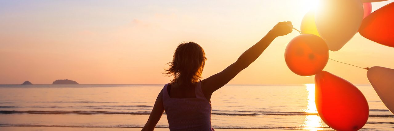 How a Wellness Recovery Action Plan Workshop Helped Me A woman holding balloons