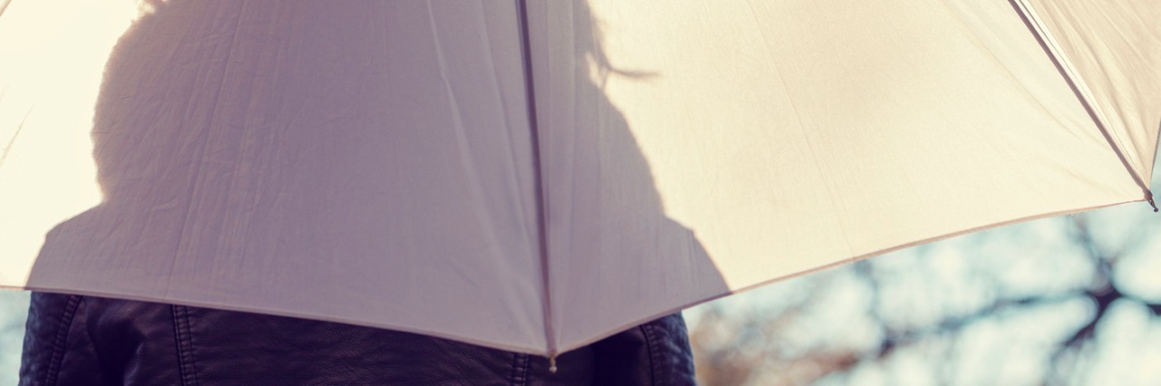 Being on ‘Hair Watch’ After Starting Chemotherapy Silhouette of woman beneath umbrella in front of trees