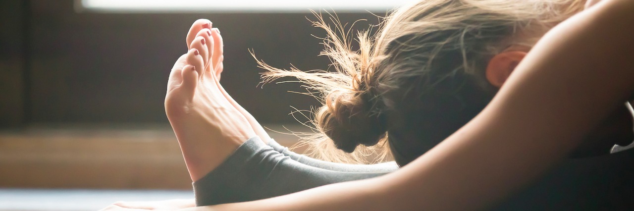 Bipolar Disorder: When Caffeine Is a Trigger for Hypomania Woman leaning over and stretching