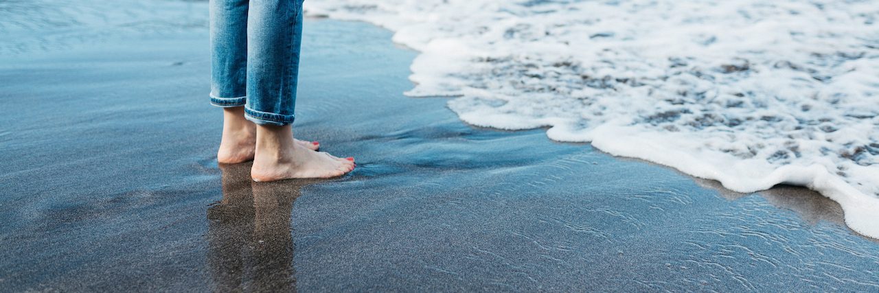 Fearing Recovery From Anorexia and Self-Harm Woman standing by the edge of the water at the beach