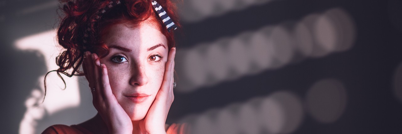 Why 'It Gets Better' Doesn't Help Someone With Depression Young woman looking worried by the window