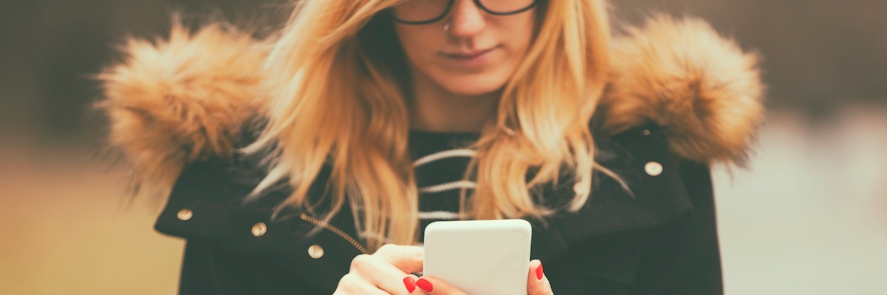 To My Parents Who Worry About My Mental Illness Woman standing outside wearing a coat