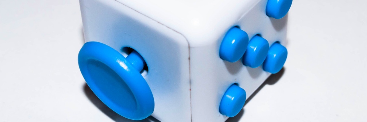 white and blue fidget cube