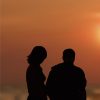 Silhouette of man and woman at sunset on beach