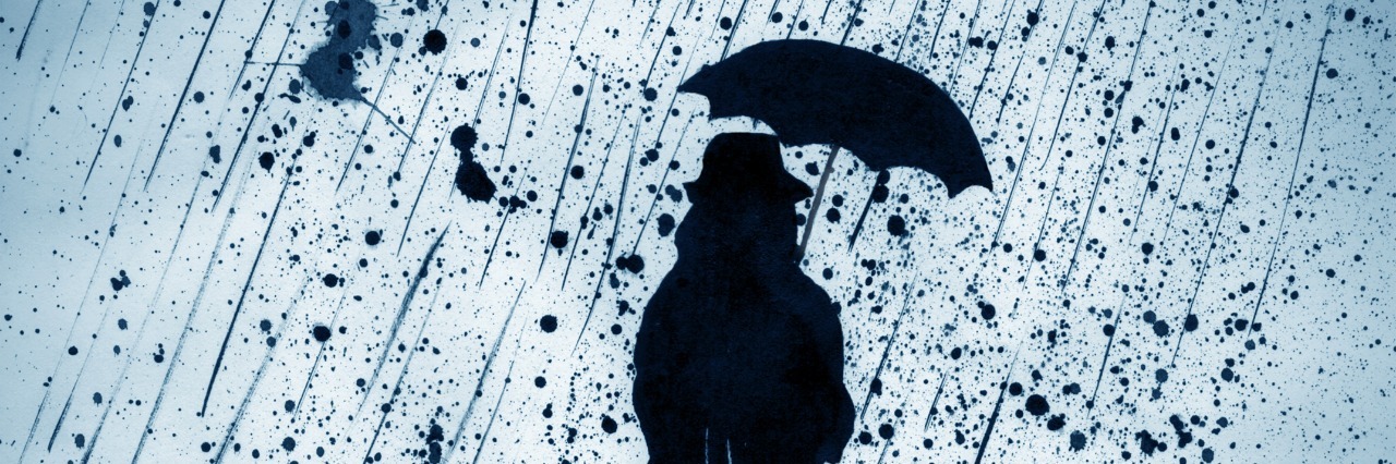 Why Living With Comorbid Disorders Is Exhausting woman under heavy rain with an umbrella
