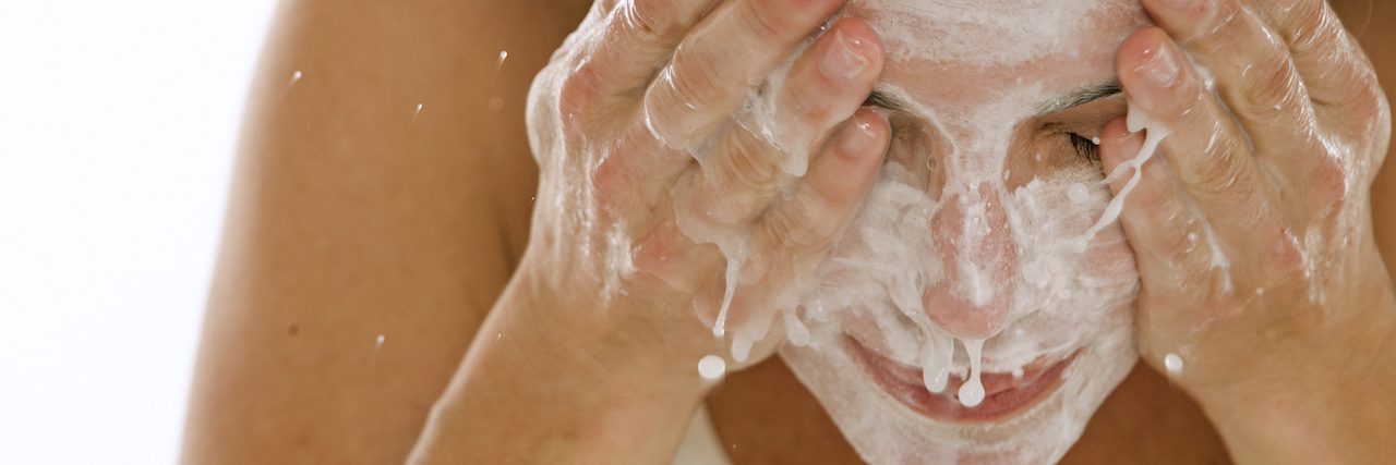 How I Practice Self-Care When I'm Facing an Overwhelming Day woman washing her face