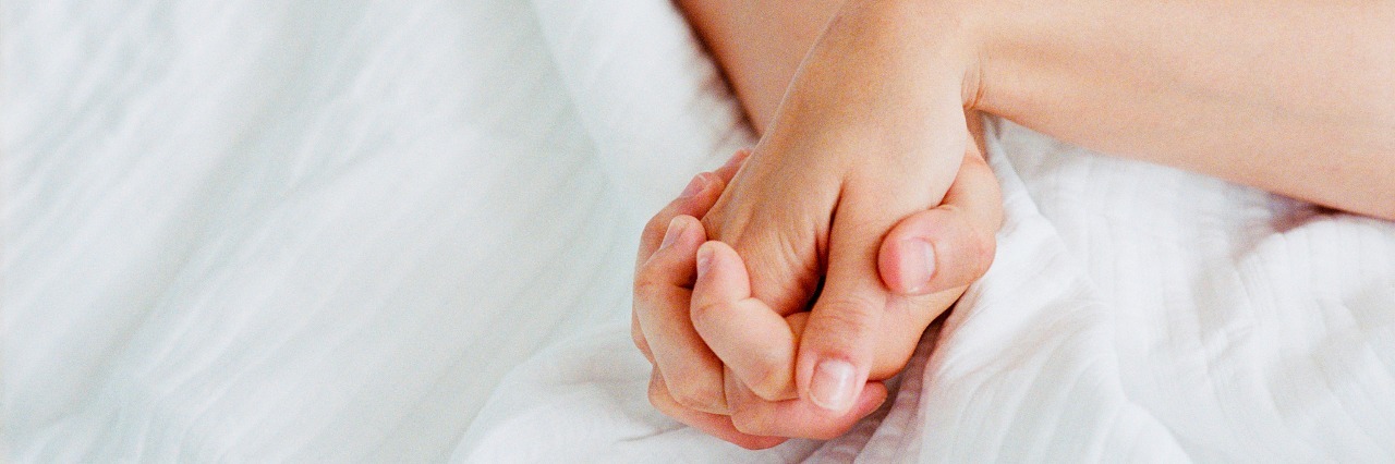 How to Help Someone Support You and Your Chronic Fatigue Syndrome hands holding on white blanket