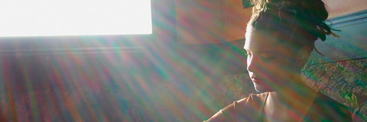 The Differences Between Words That Describe Being Sick woman sitting at table alone