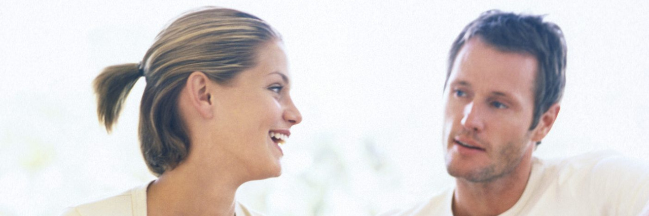 Improving Communication When One Partner Is Hard of Hearing Couple on couch talking.