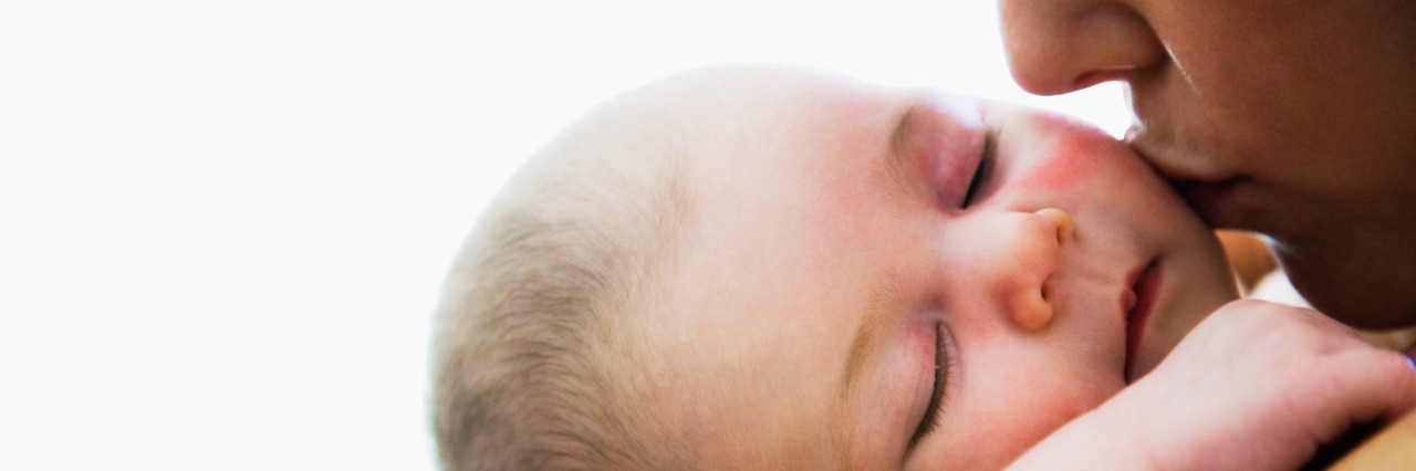 When Depression Makes You Feel Like an Awful Parent Mother kissing sleeping infant