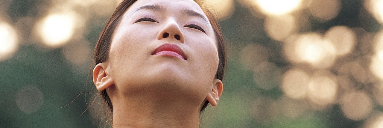 Questioning Why I Share My 'Intimate' Mental Illness Story woman looking up in the sun