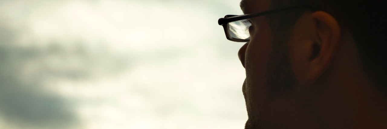 Disability Inspiration Stories: What They Miss Profile of man wearing glasses, looking toward clouds in sky