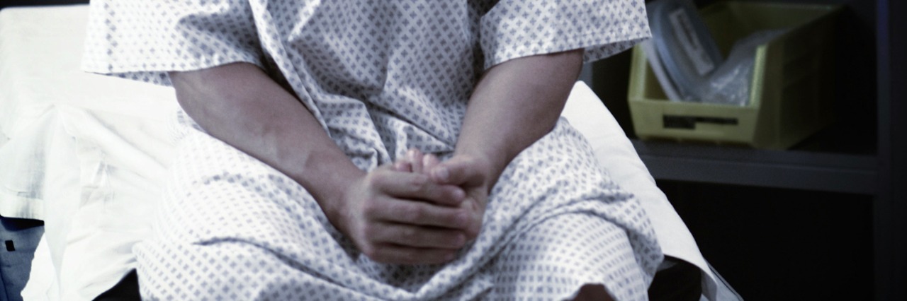 What Doctors Should Know About Patients With Anxiety Man in hospital gown, sitting on hospital bed