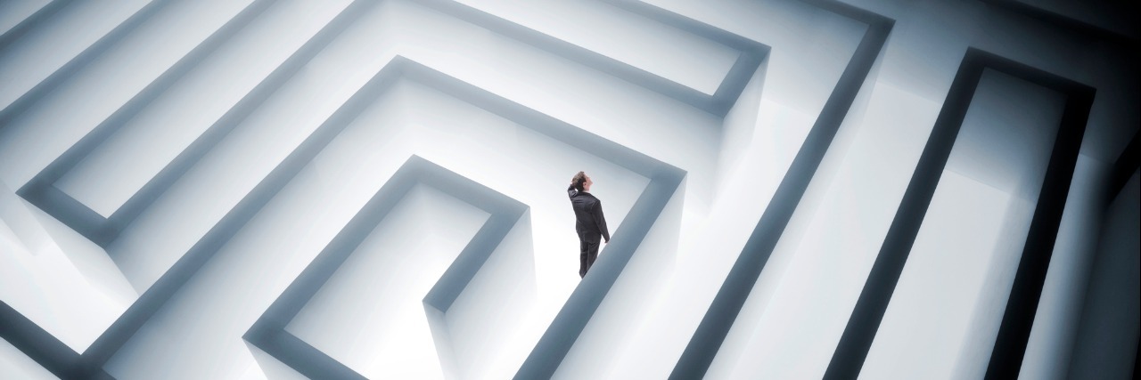 When Chronic Illness Is Like Walking A Labyrinth man walking in giant maze