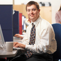 Young man with Down syndrome working in an office.