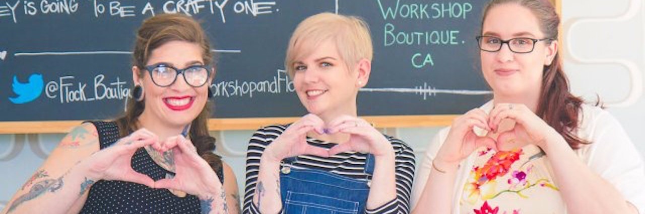 Style, Fashion and Comfortable Clothing for People in Chronic Pain three women with chronic illnesses making hearts with their hands, smiling, and wearing fashionable clothing