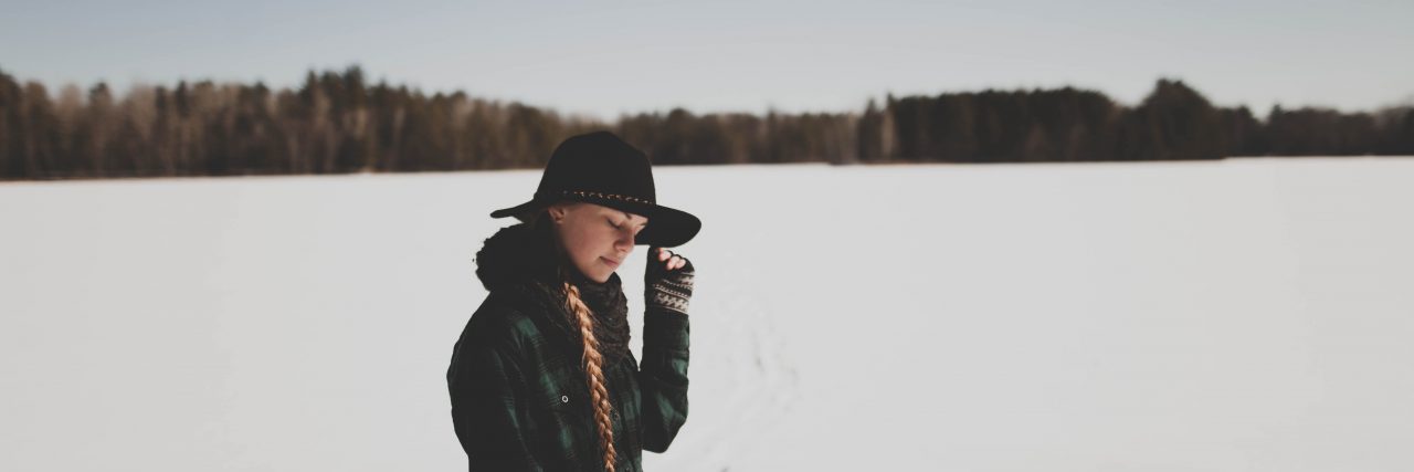 Hiding the Depression That Came With My PCOS sad woman in the snow