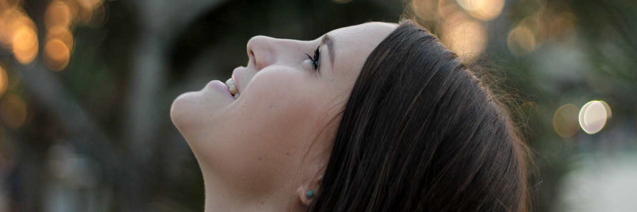 Learning to 'Live Again' During Eating Disorder Recovery smiling woman with dark hair looking up