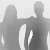 Silhouettes of women, one has her arm on shoulder