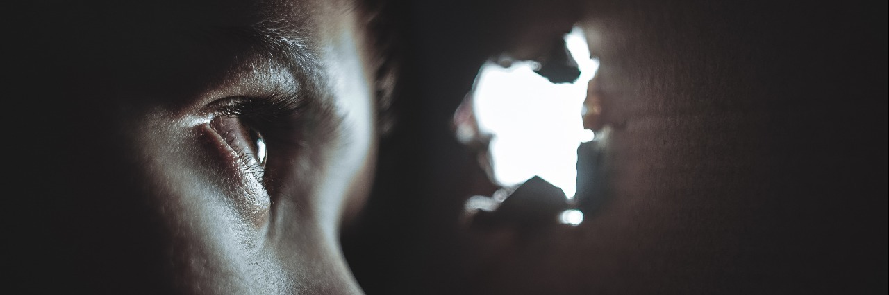 When Your Mask Comes off and You Have a 'Meltdown' person looking through hole in cardboard wall