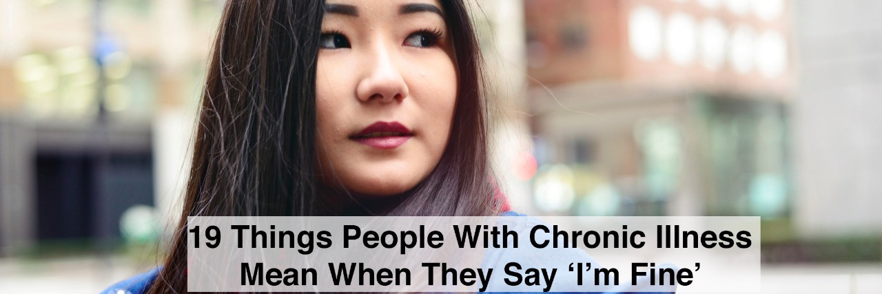 19 Things People With Chronic Illness Mean When They Say 'I'm Fine' A young woman looking up at downtown buildings. with text 19 things people with chronic illness mean when they say im fine