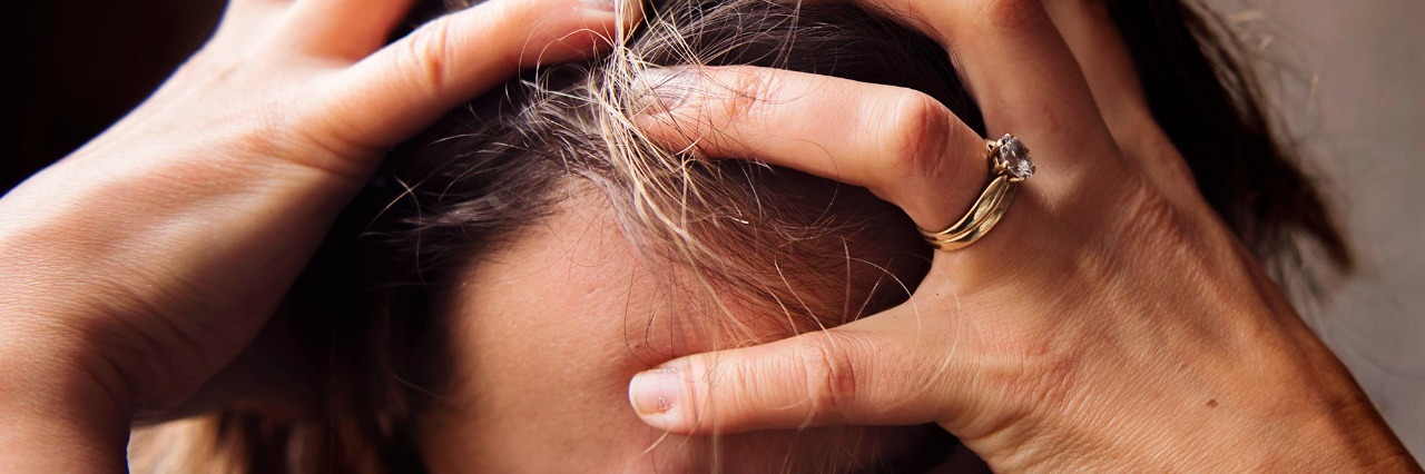 6 Lies My Chronic Pain Tells Me on the Worst Days woman holding head