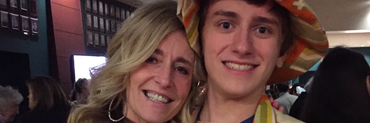 How a High School Musical Gave My Autistic Son a Stage Mother and son hugging, with son in costume from school play