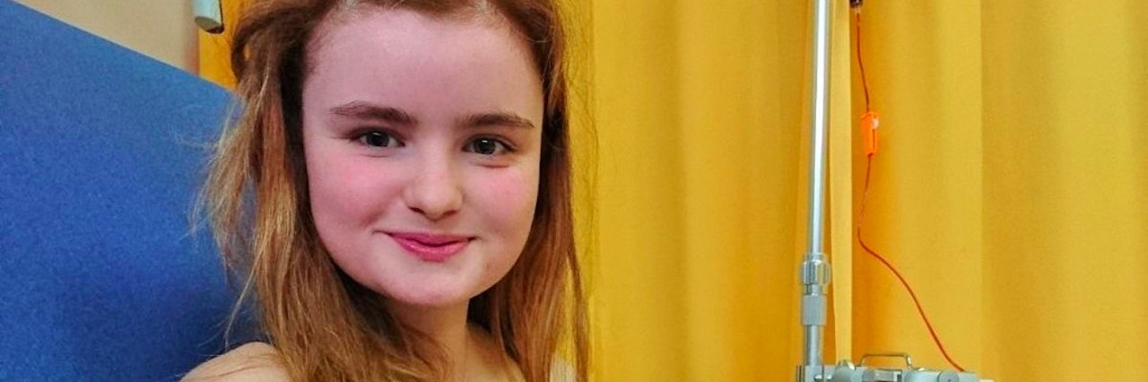 8 Things I've Had to Accept Since My Diagnosis Woman sits in hospital chair, IV in left arm.