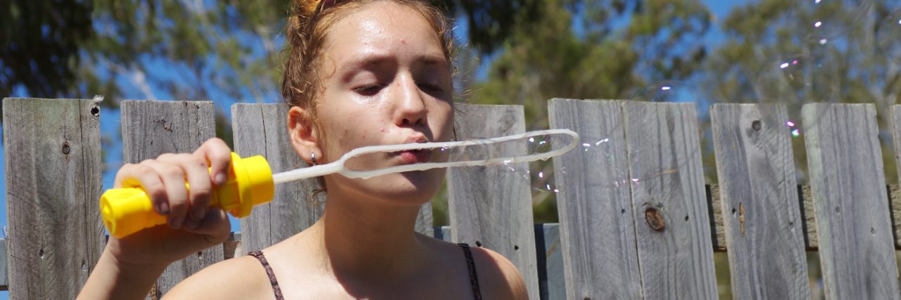 How We Show Our Autistic Daughter She Is Loved girl blowing bubbles