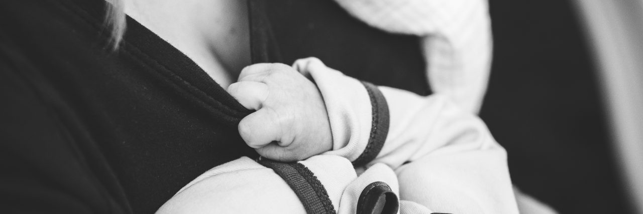 We Need to Talk About Postpartum PTSD baby holding onto mom's shirt