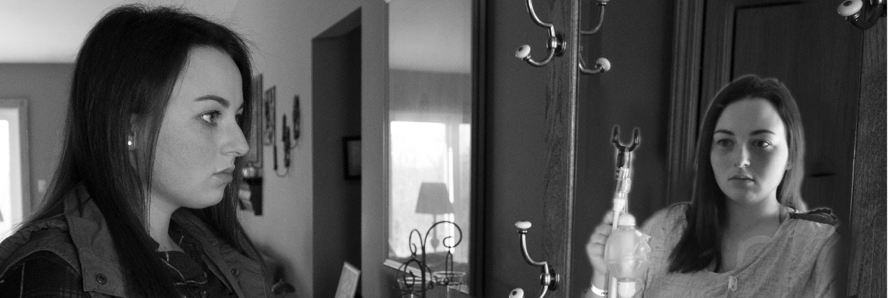 Why Birthdays Can Be Difficult When Chronically Ill Woman reflect in the mirror, seeing her self in a hospital gown with an IV bag