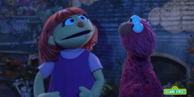 Sesame Street muppets Julia and Elmo singing outdoors at night