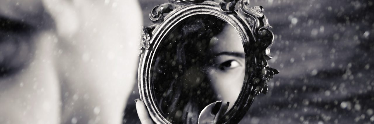 Why We Need to Change the Way We Talk About Skin Cancer girl looking at reflection in mirror, you can only see her eye