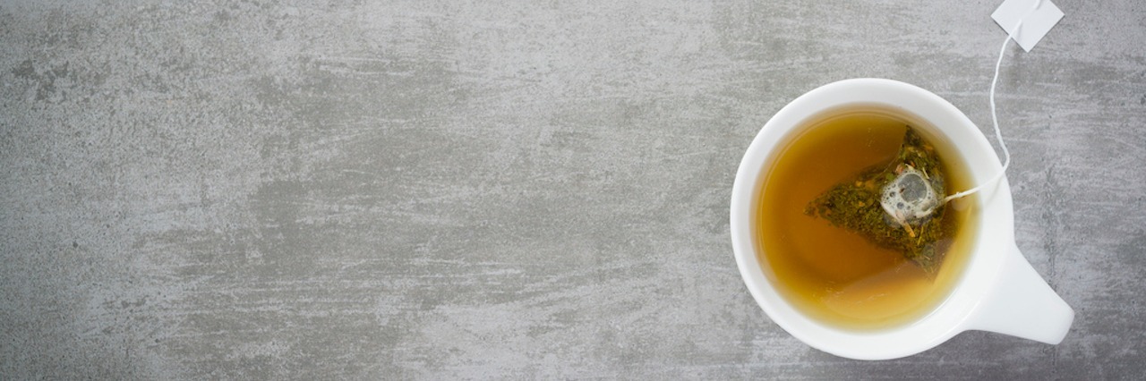 Finding Hope in a Psychiatric Hospital Encouraged Me to Help Others Cup of tea with teabag, on concrete stone background