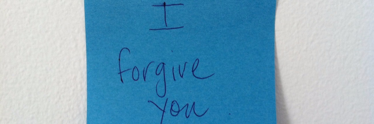 Dear Anxiety: I'm in Recovery and I Forgive You blue post it note with I forgive you written in pen and stuck to wall